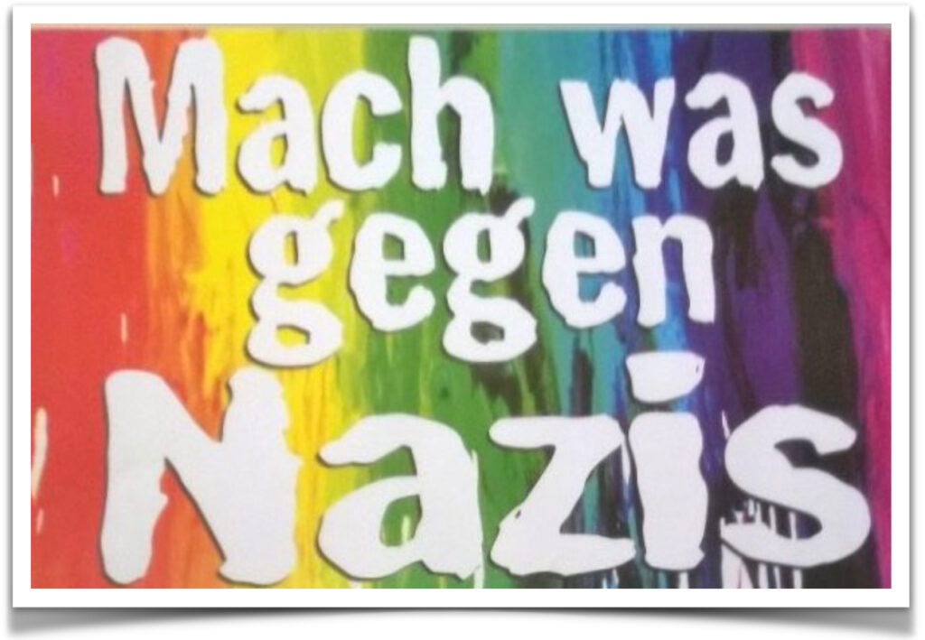 Auf regenbogenfarbenem Hintergrund die weiße Aufschrift 'Mach was gegen Nazis'